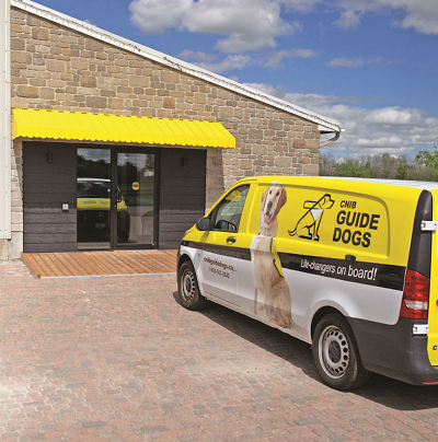 close up of a CNIB Guide Dogs van parked in front of the canine campus