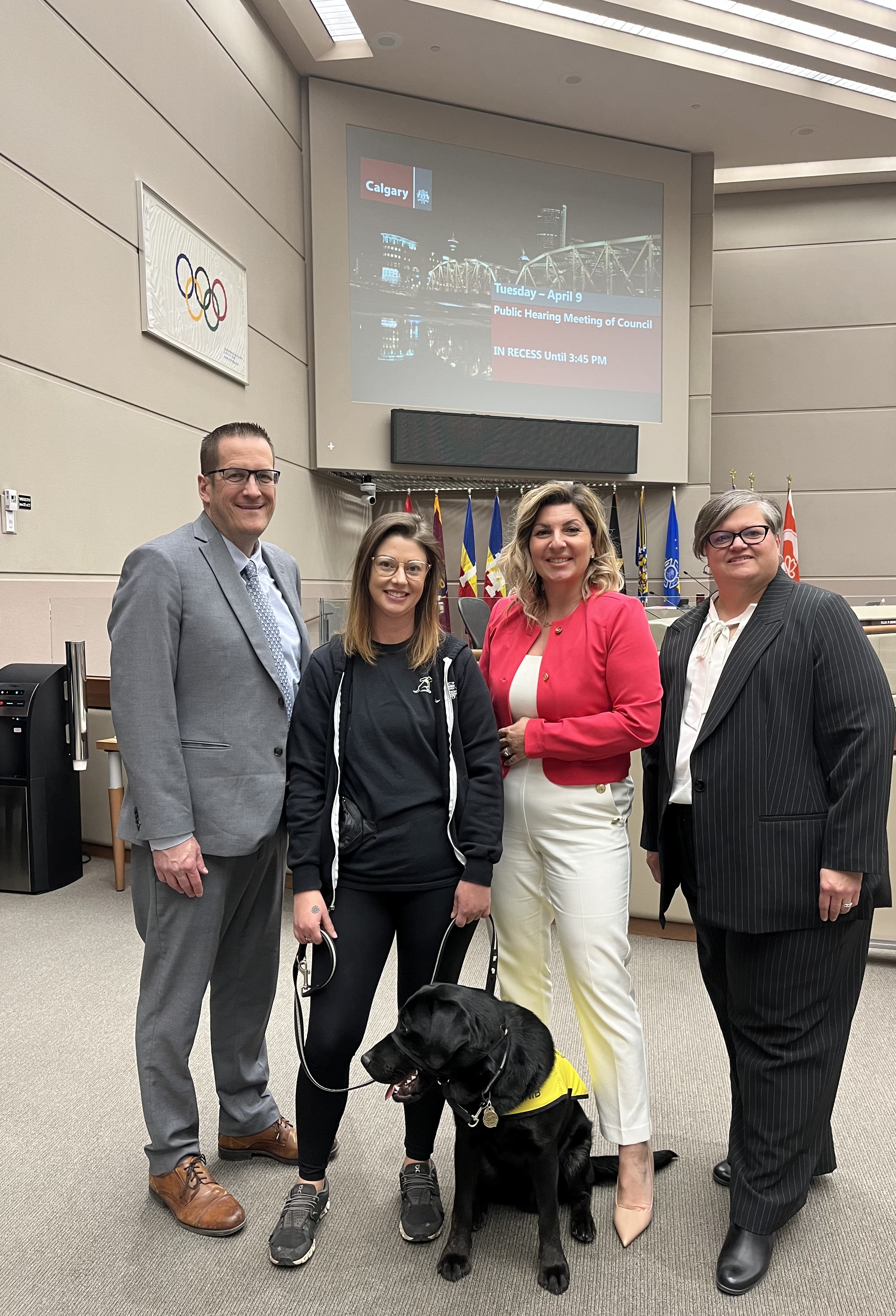 Craig Peterson, Executive Director, Alberta and Northwest Territories, CNIB; Kezia Gray, Trainer, Puppy Development, CNIB Guide Dogs with a puppy in training; Angela Bonfanti, Chief Operating Officer, CNIB and Christall Beaudry, Vice President, Western Canada, CNIB at the City of Calgary Public Hearing Meeting of Council on Tuesday, April 9, 2024.