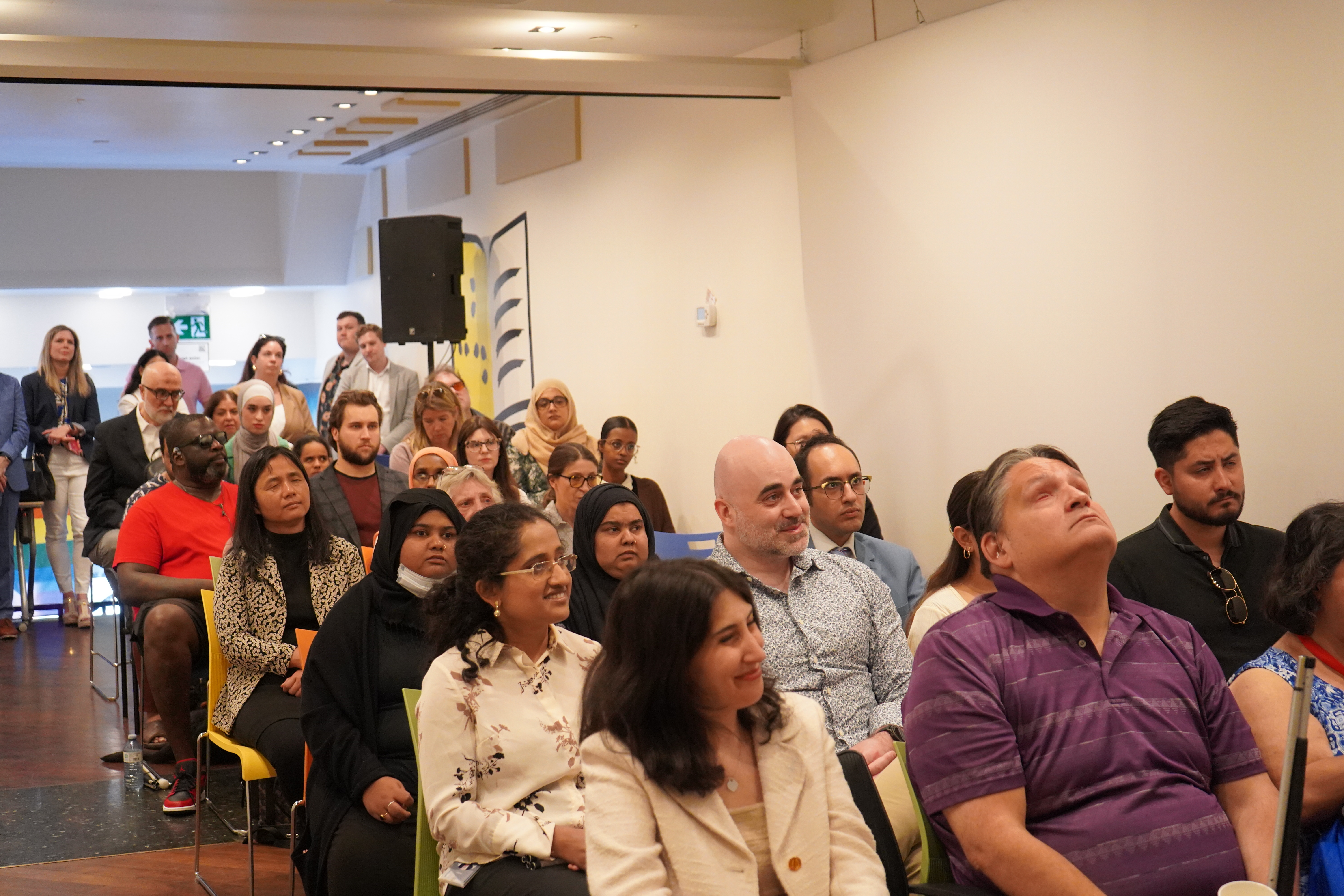 A group of staff, employer partners and come to work participants gather at the Toronto Hub for the Come to Work event.