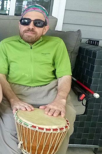 Photo of Bill Vastis at CNIB Lake Joe. He's playing the drums.