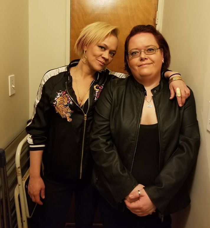 Jaclyn (right) and her cousin, Alexandria pose for a picture indoors. Alexandria has her arm around Jaclyn’s neck.