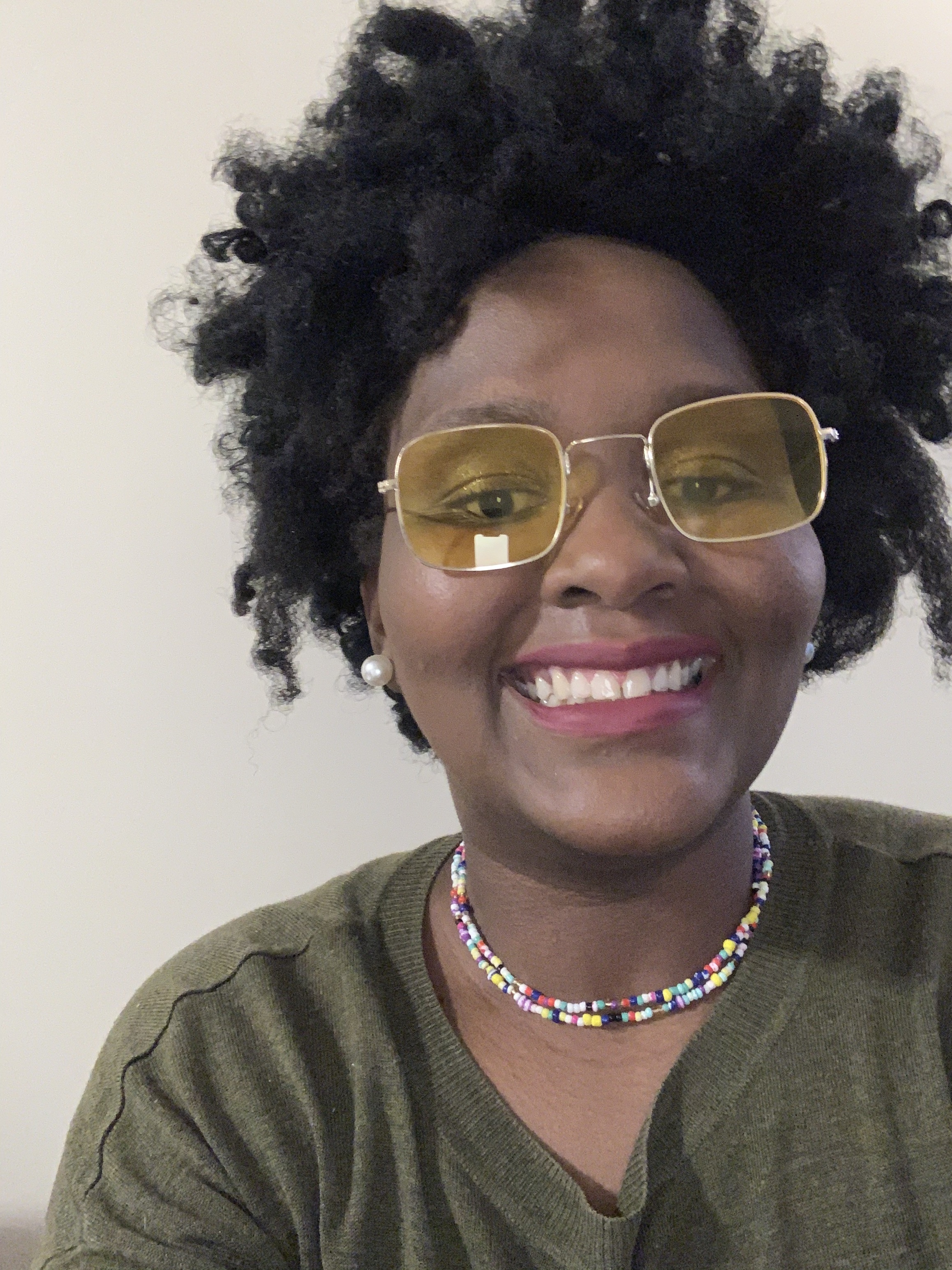 A headshot photograph of a smiling Lucie.