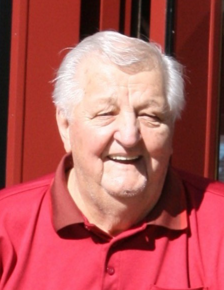 Roy Klementti smiling, wearing a red golf shirt 