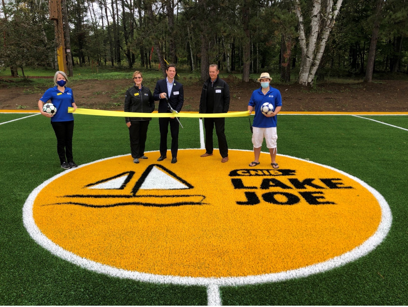 Ribbon-cutting on the new CNIB Lake Joe soccer pitch. From left to right: Sherri & Monique (CNIB Lake Joe), Dan & Mark (Synthetic Turf Council) and Josh (CNIB Lake Joe)
