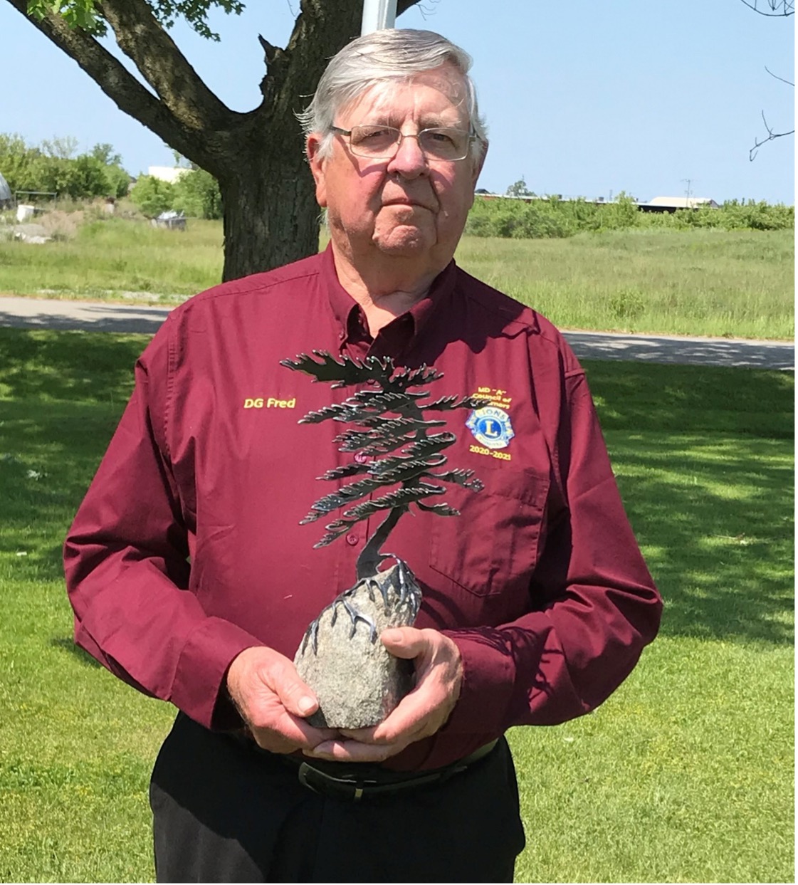 Fred Arbour, District Governor A2, holding the District of the Year Award, 2020-21