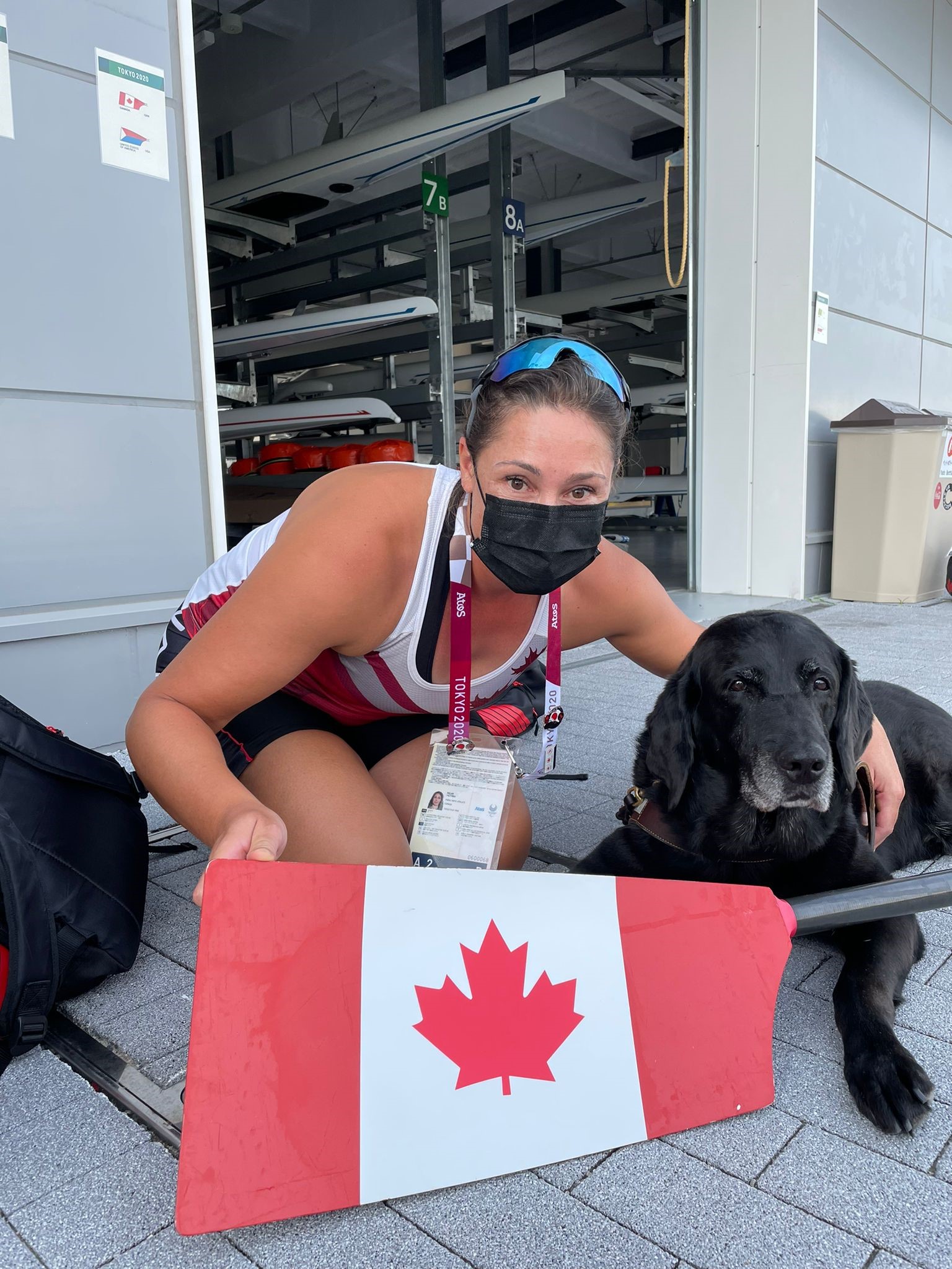 Victoria and her guide dog Alan, a black Labrador retriever