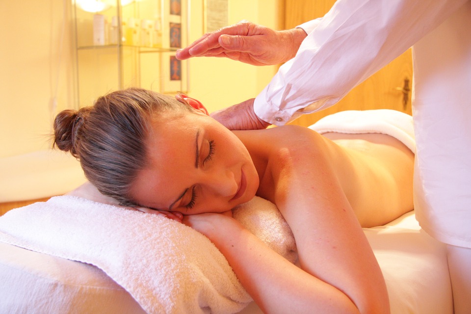 A woman gets a back massage at a spa