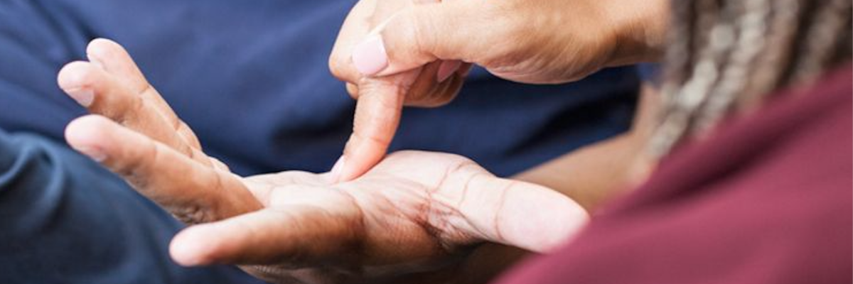 An intervenor uses print on palm to communicate with a client. 