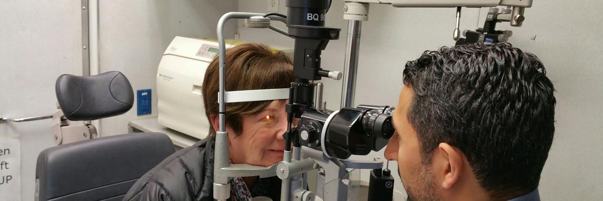 A woman getting her eyes checked by an optometrist