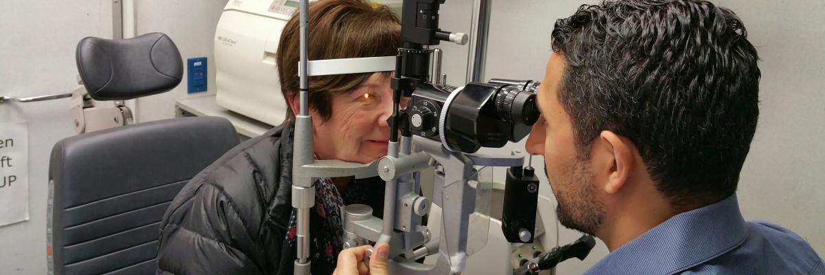 Woman getting her eyes checked by optometrist