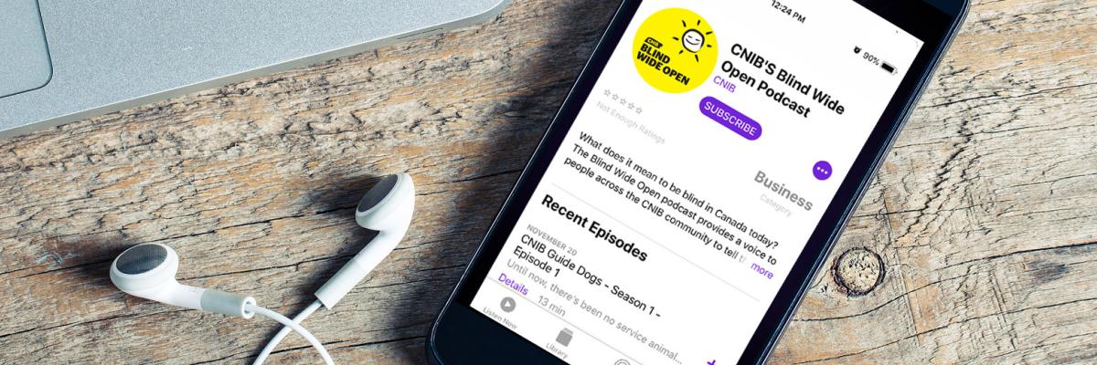 An iPhone with earbuds; the screen showing Blind Wide Open playing in the Podcast app.