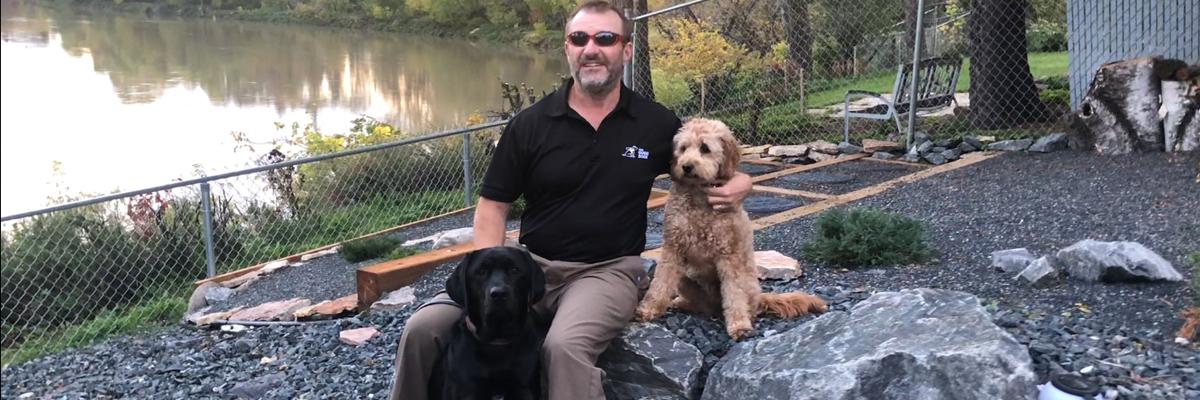 Tracy with Marion, black Labrador Retriever and Autumn, Tracy’s pet dog.