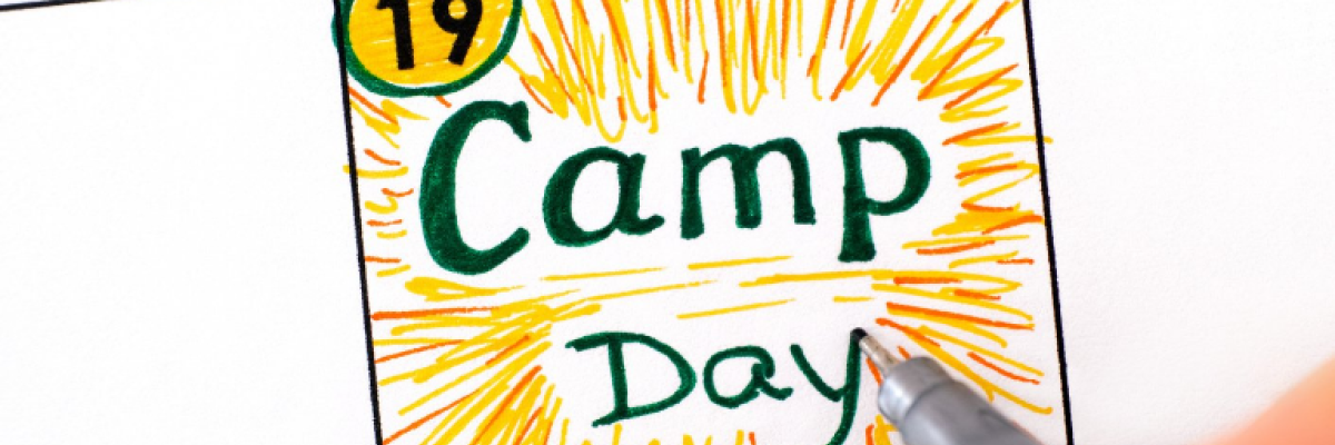 The words "Camp Day" written on a calendar with yellow streaks to make it look like sunshine 