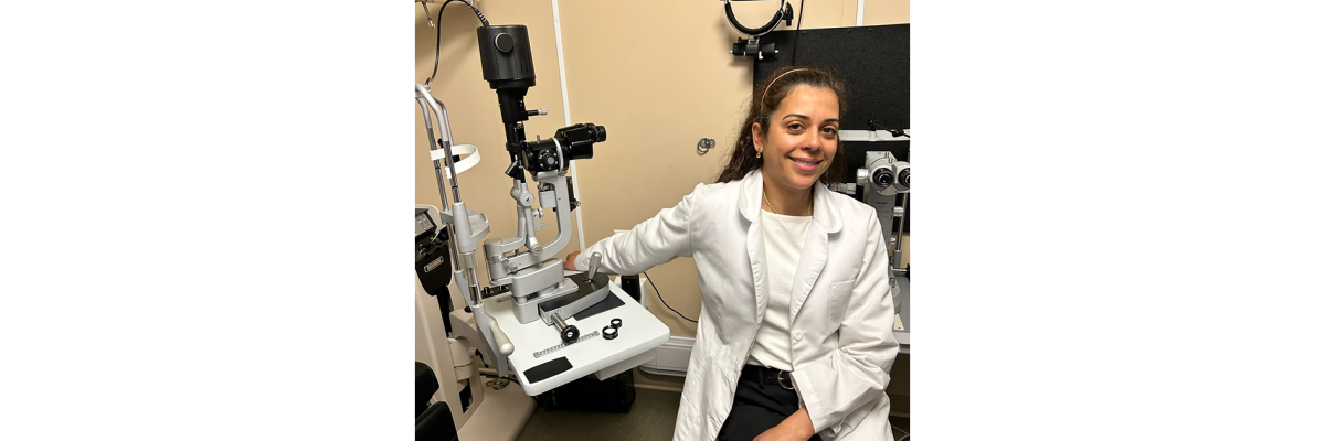 Dr. Danah Al-Breiki, Opthamologist sitting in a doctor office with a white lab coat on