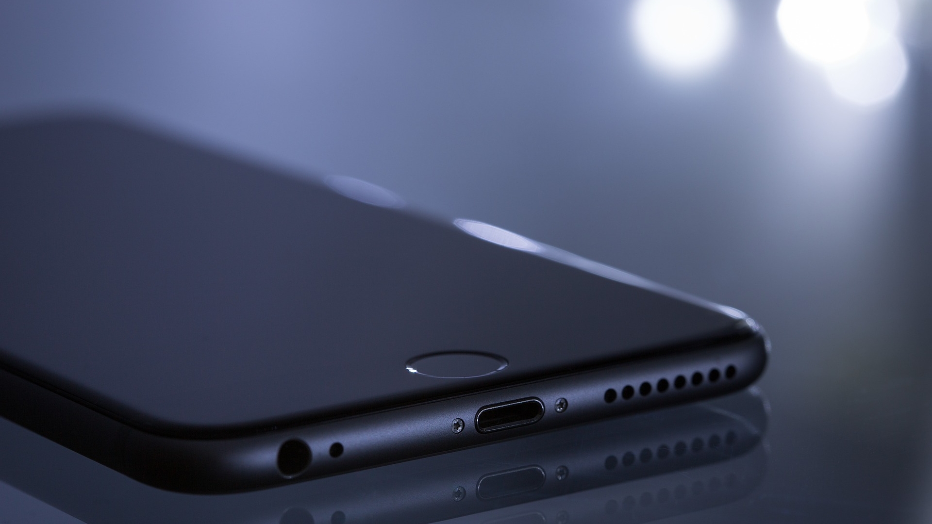 Iphone couché sur fond noir avec lumière
