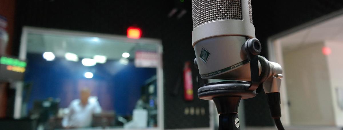 Image of a microphone placed in a recording studio. 