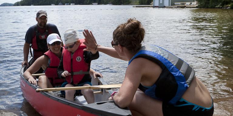 un groupe de campeurs dans un canot. une haute de cinq un chef de camp.