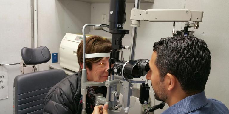 A woman getting her eyes checked by an optometrist