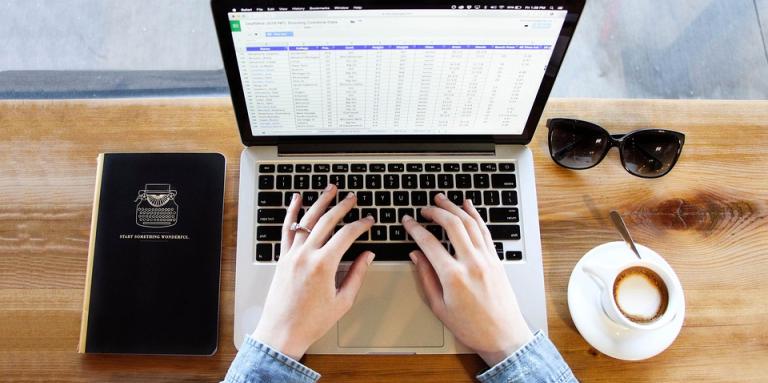 Person typing on a laptop 