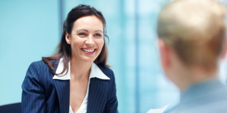 Businesswoman smiling and holding paper