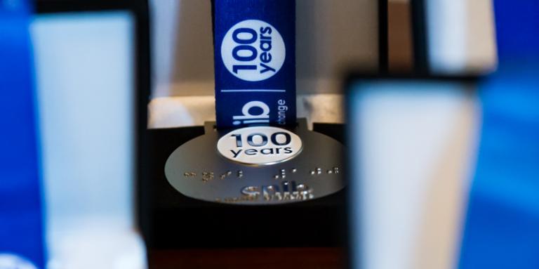 CNIB Century of Change award medals in their open boxes with their blue ribbons out on display