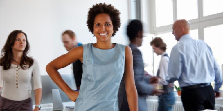 smiling businesswoman in busy office