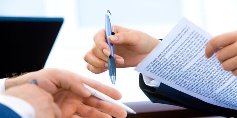 mains tenant un crayon analysant une lettre