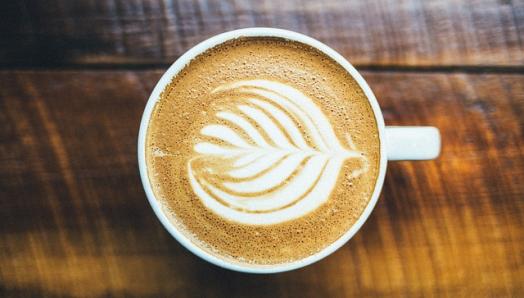 A coffee cup sits on a table.