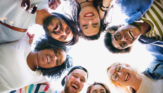 o	Seven young people link arms around one another and form a circle of support.