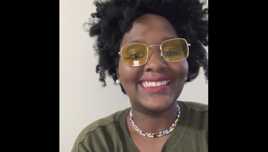 A headshot photograph of a smiling Lucie.